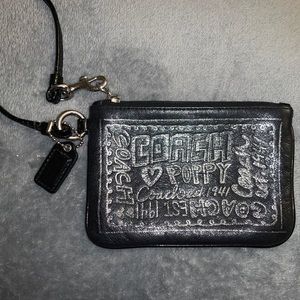 Black and silver coach wristlet